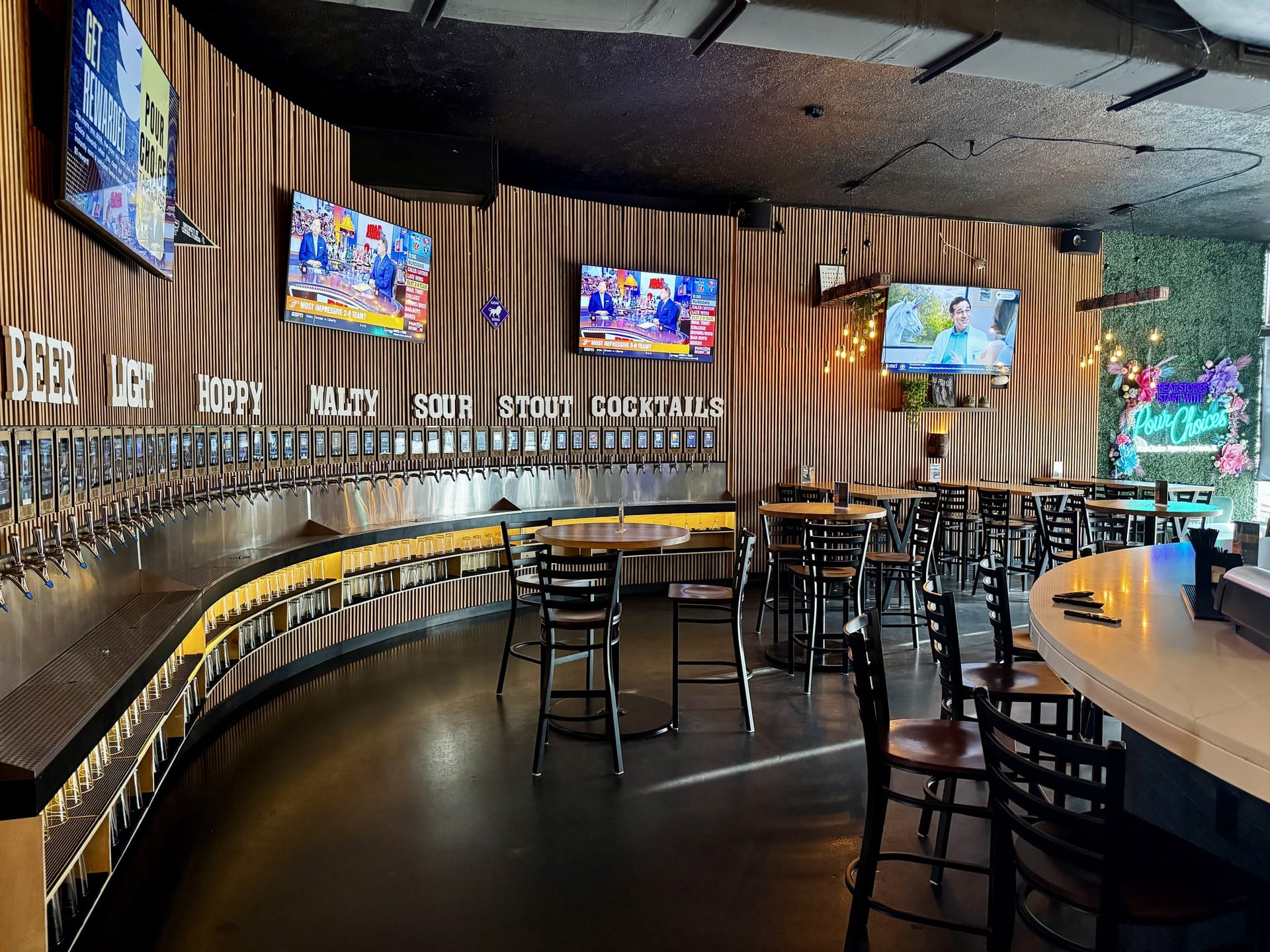 Self-serve tap wall and high-top seating inside Pour Choice Taphouse in Mills 50 Orlando