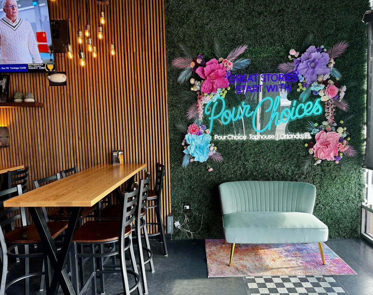 Neon Great stories start with Pour Choices floral wall and mint sofa at Pour Choice Taphouse in Mills 50 Orlando