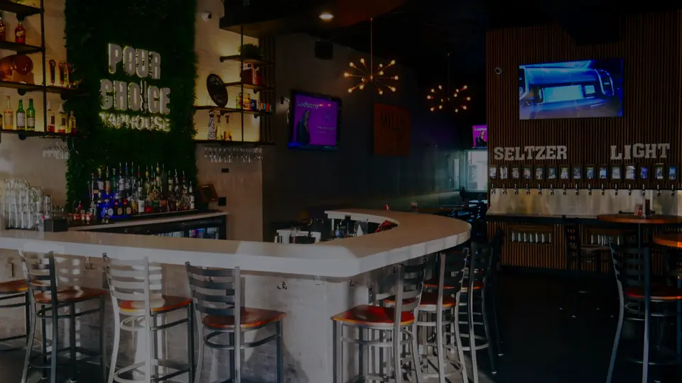Interior view of Pour Choice Taphouse showing self-pour beer wall and full liquor bar in Orlando's Mills 50 District